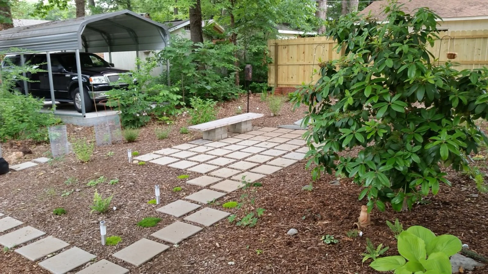 Curved pool surrounded by decorative concrete